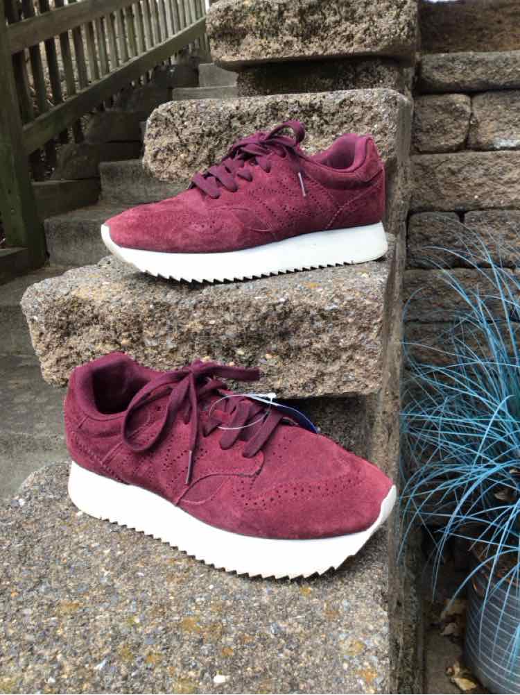 Burgundy suede New Balance sneaker with white platform sole and lace-up design, size 7.