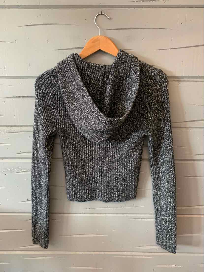 Gray cropped knit sweater with long sleeves and a hood hanging on a wooden hanger.