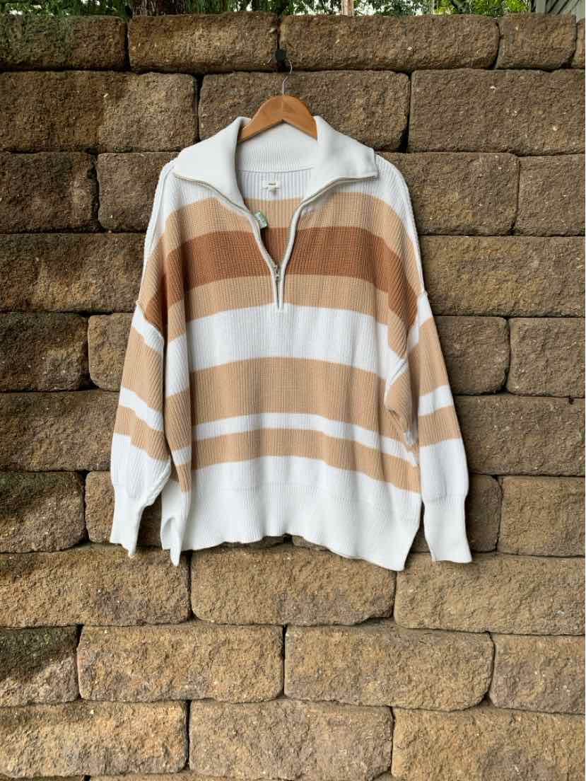 Long-sleeve pullover with wide horizontal beige and cream stripes, half-zip collar, and ribbed cuffs and hem.