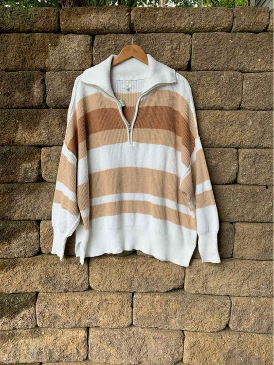 Long-sleeve pullover with wide horizontal beige and cream stripes, half-zip collar, and ribbed cuffs and hem.