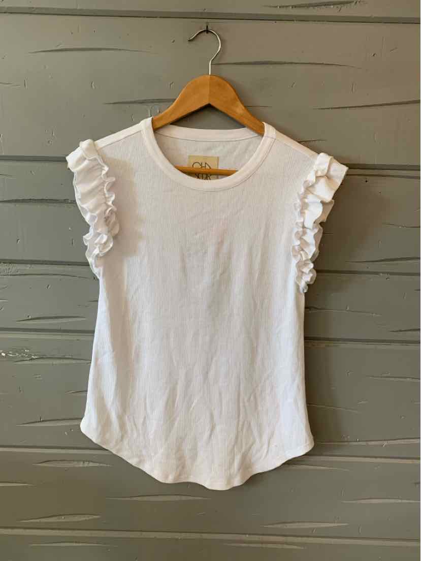 White sleeveless top with ruffled shoulder details and round neckline, soft fabric.