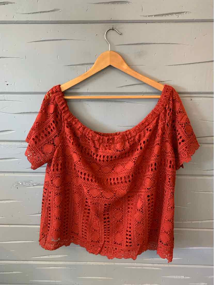 Red lace short-sleeve blouse with wide scoop neckline and intricate floral patterns.