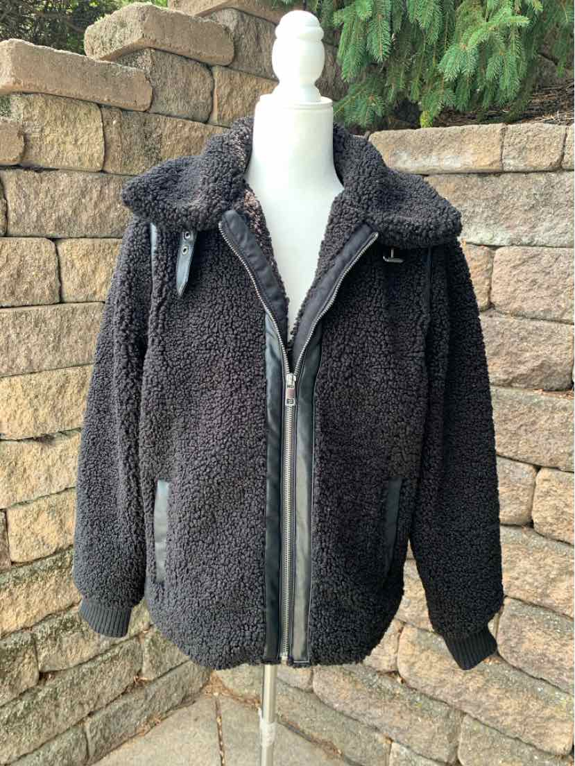 Black medium-size teddy fleece jacket with front zipper and drawstring hood.