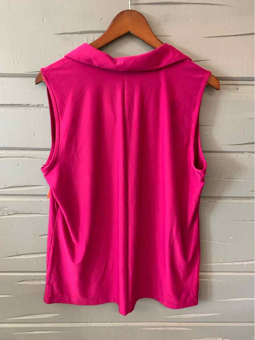 Sleeveless bright pink blouse with wide collar on wooden hanger against white wooden wall.