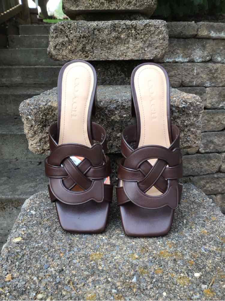 Brown leather slip-on sandals with woven straps and square toes, size 6.