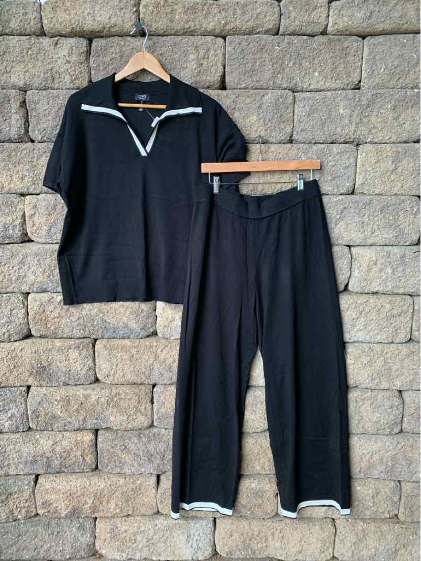Black two-piece loungewear set with short-sleeve top and wide-leg pants, white trim detailing.