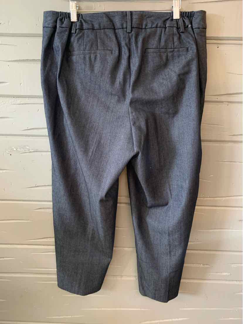 Gray tailored ankle-length trousers with back pockets and belt loops.