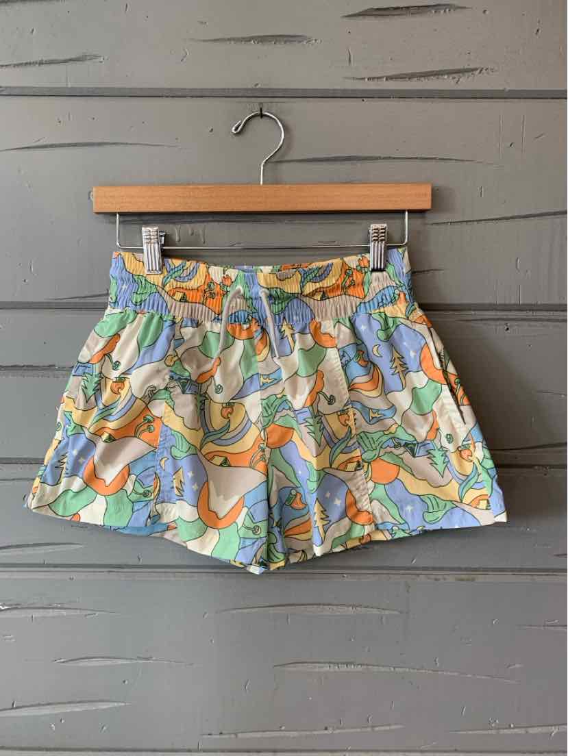 Colorful high-waist shorts with an abstract pastel pattern in blue, orange, green, and white, featuring a button and zipper.