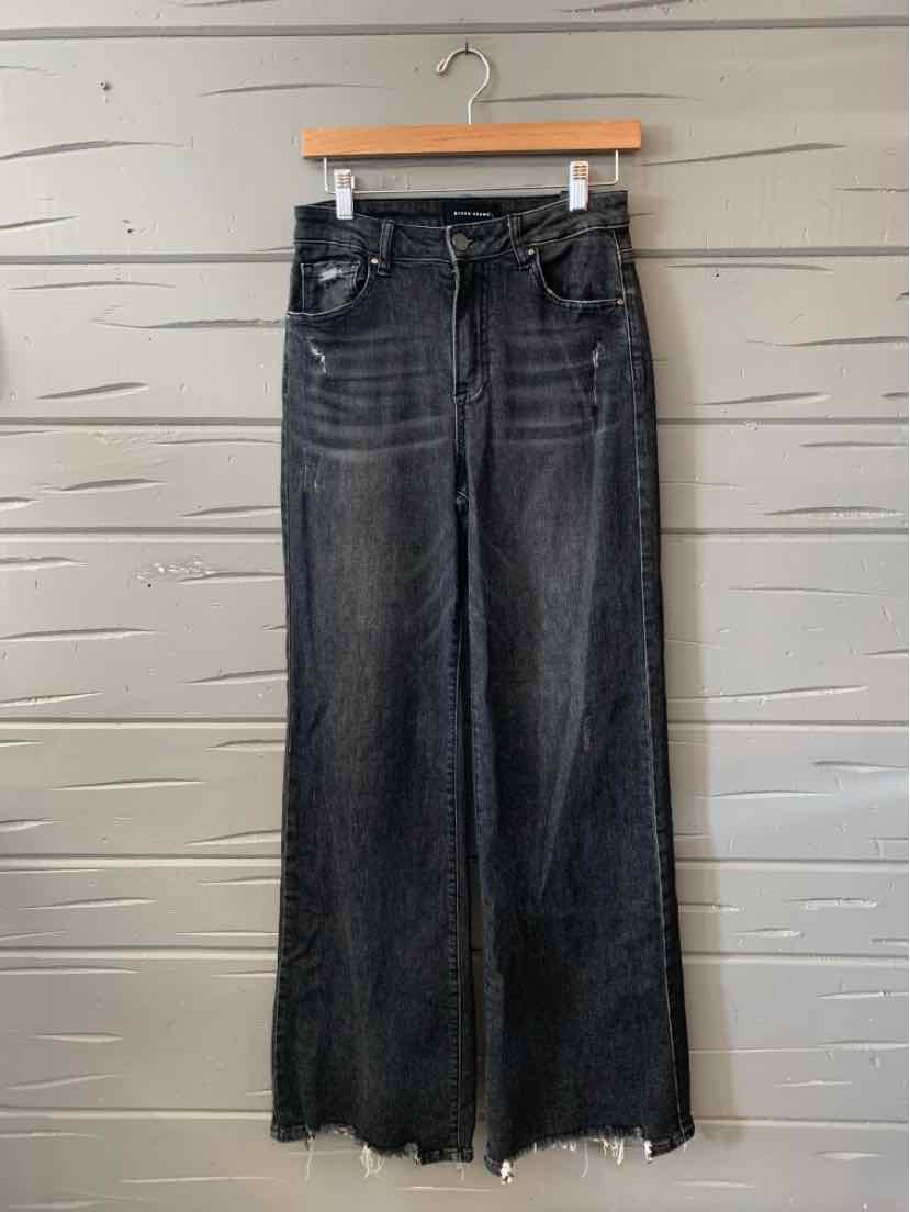 Black high-waisted wide-leg denim jeans with distressed hems and front pocket detailing.