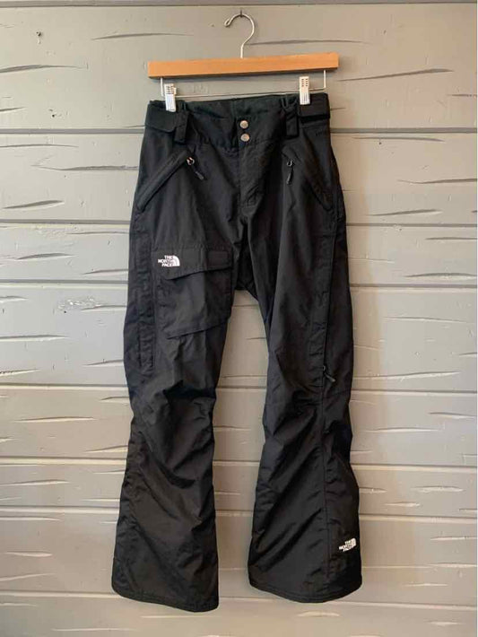 Black The North Face women’s outdoor pants with cargo pockets, zippered details, and relaxed straight legs.