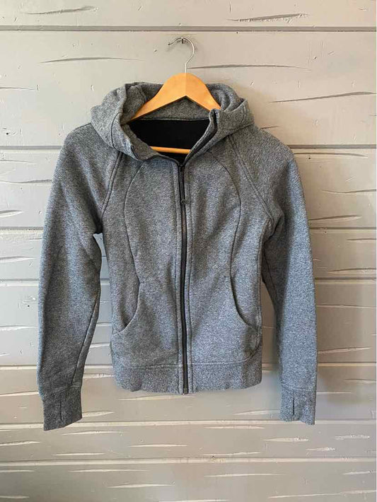 Gray zip-up hoodie with front pockets and fitted cuffs, made from soft knit fabric.