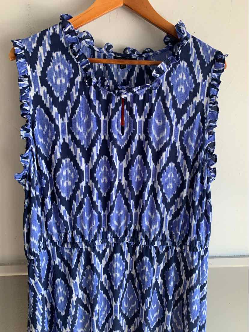 Blue sleeveless dress with geometric pattern and gathered waist on wooden hanger.