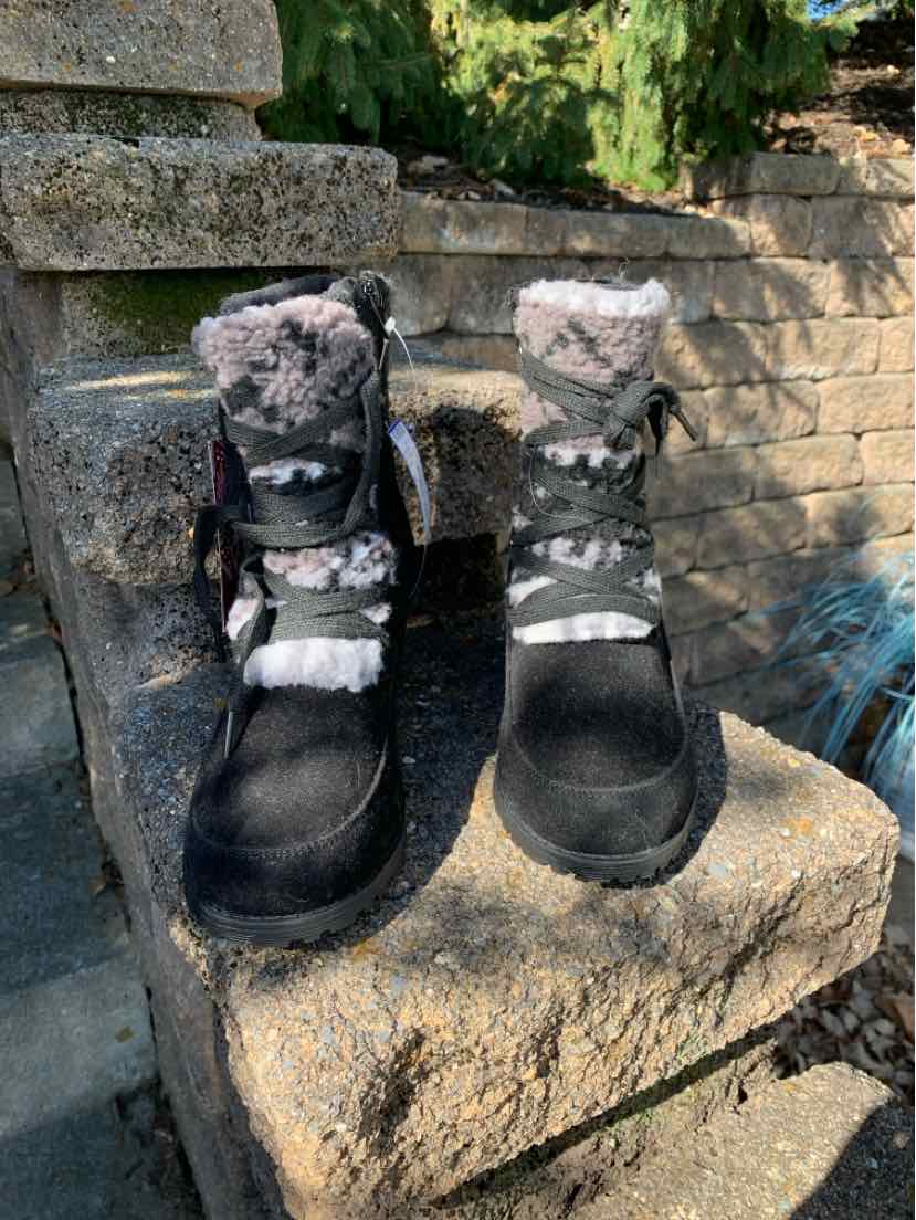 Pair of black Muk Luks ankle boots with fuzzy gray-and-white cuffs and decorative straps.
