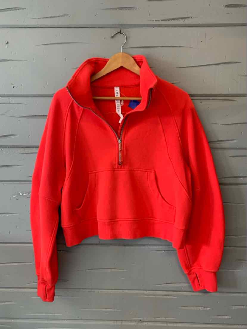 Red cropped women’s quarter-zip sweatshirt with a high collar, long sleeves, and front kangaroo pocket.