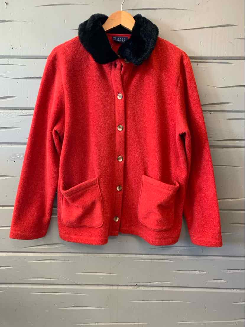 Red fleece cardigan with a black plush collar, button front, and two patch pockets.