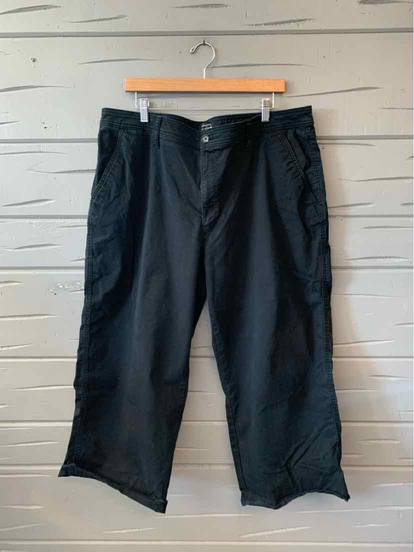 Black mid-length shorts with a relaxed fit, button and zipper closure, and side pockets.