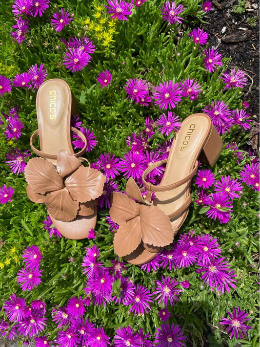 Tan leather open-toe slide sandals with layered petal detail on straps, size 8.