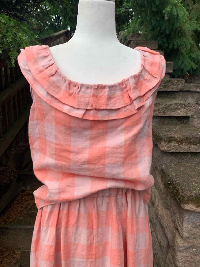 Coral and white gingham sleeveless top with ruffled boat neckline and elastic waist.