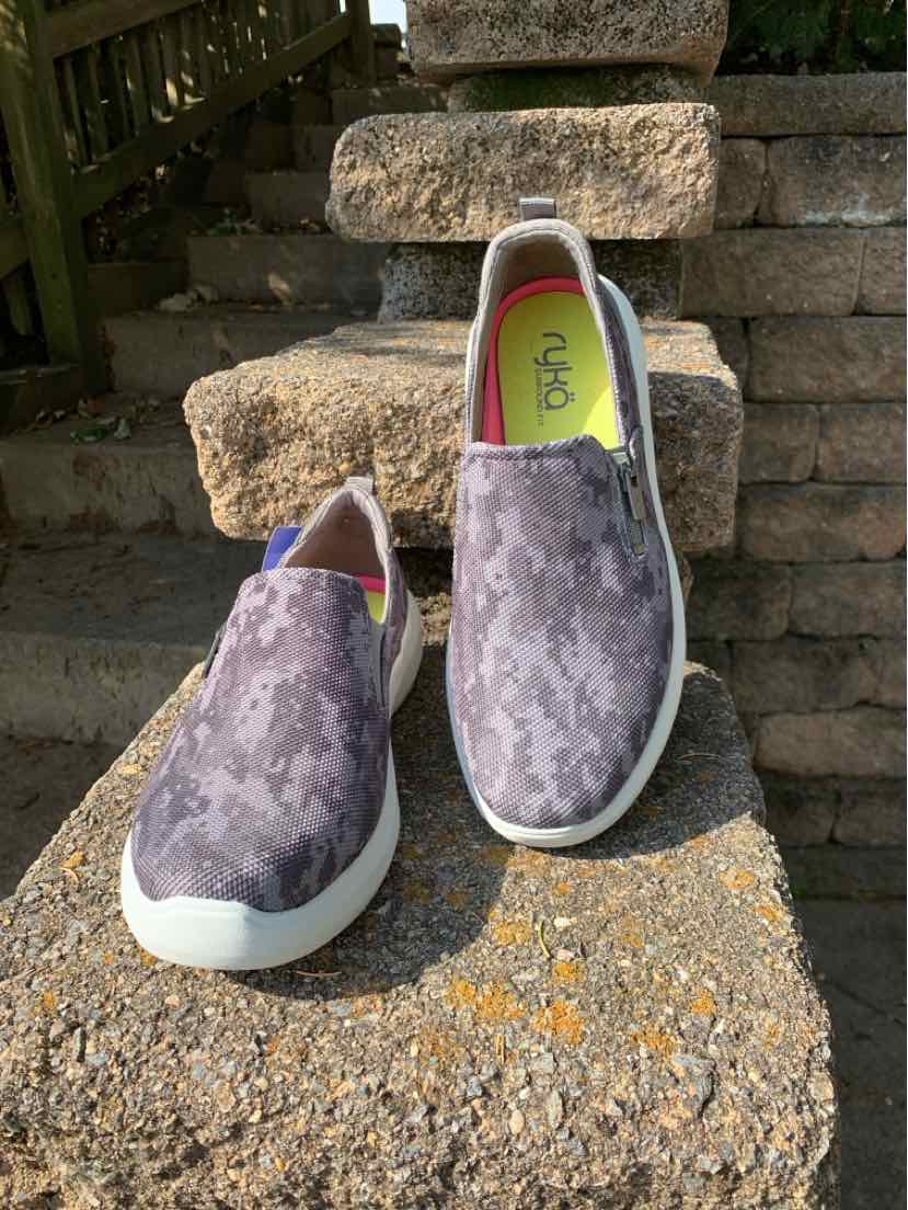 Women’s Ryka slip-on sneakers in mottled purple-gray fabric, with white soles and lime green lining.