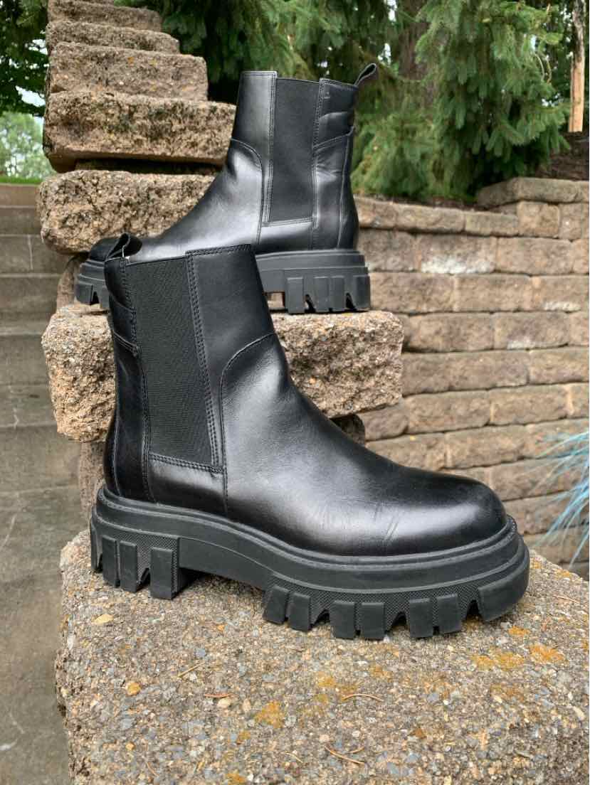 Black chunky platform ankle boots with smooth leather upper and elastic side panels.