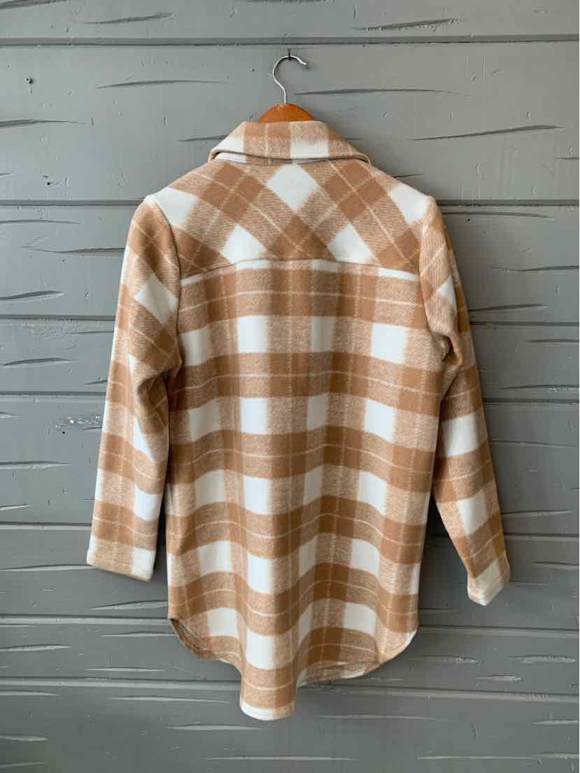 Tan and white plaid long-sleeve shirt with a relaxed fit hanging on wooden hanger.