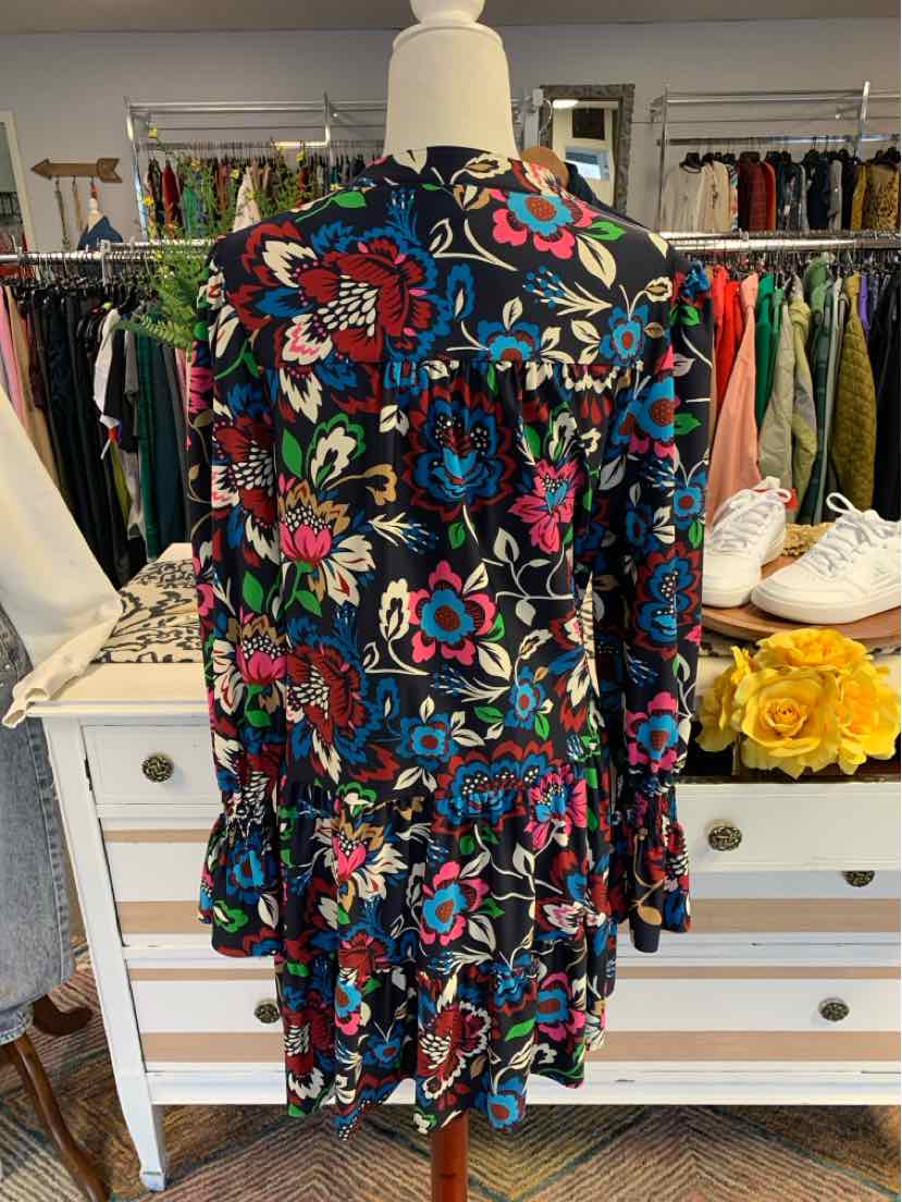Floral long-sleeve dress with ruffled hem in navy, red, pink, and green on a mannequin.