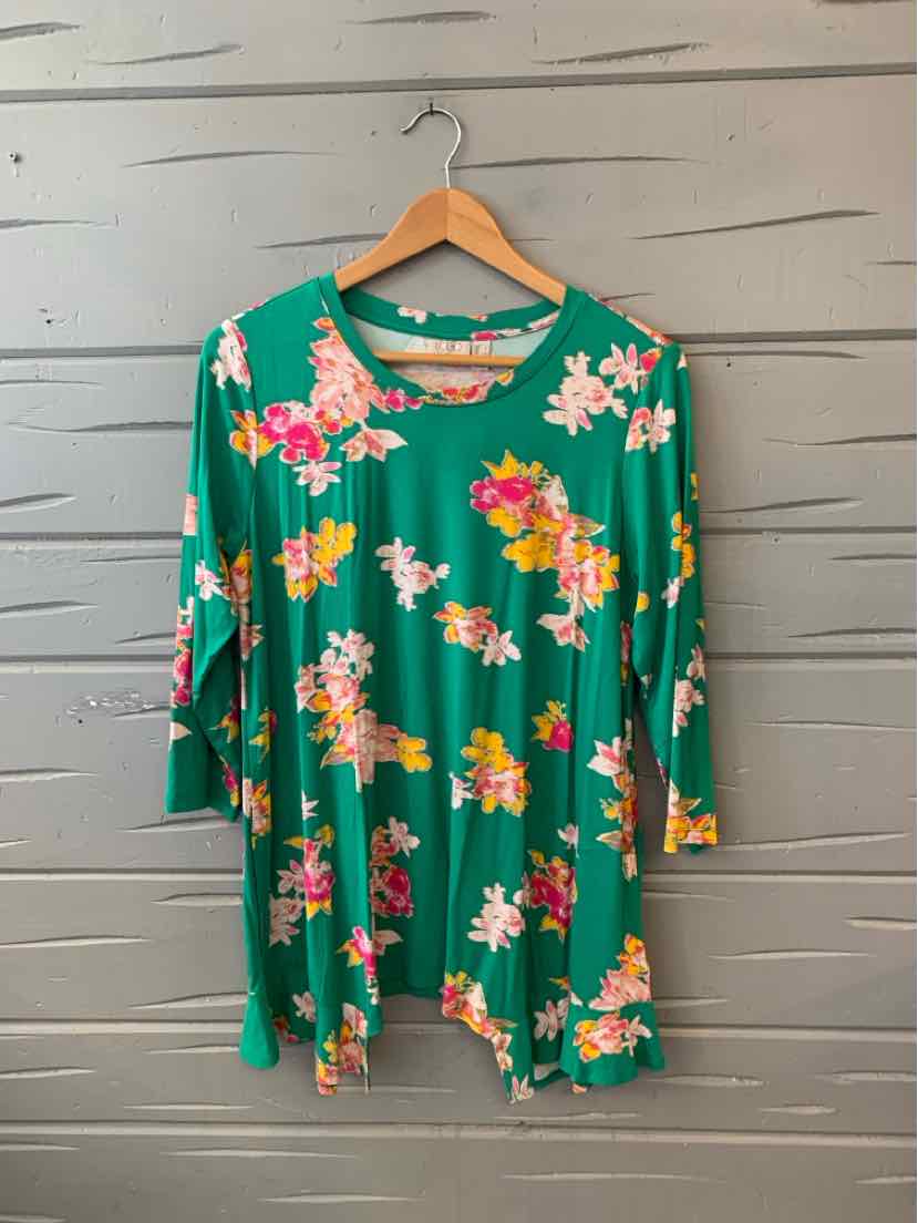 Green long-sleeve floral tunic with pink, white, and yellow flowers and loose fit.