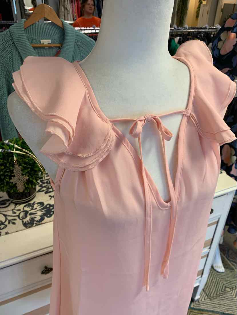 Light pink dress with ruffled short sleeves and a front tie neckline on a mannequin.