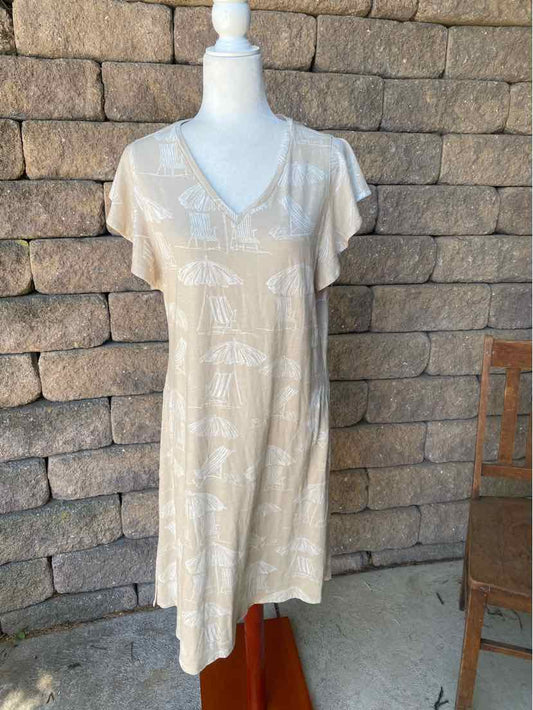 Light tan knee-length dress with short sleeves, V-neck, and subtle white floral pattern.