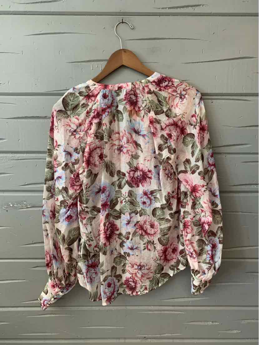 Long-sleeve floral blouse in pink, red, and green tones with a gathered neckline and cuffed sleeves.