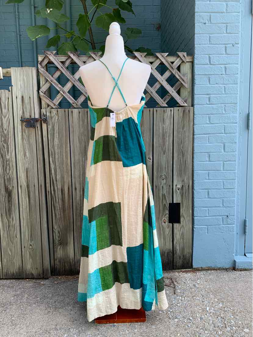 Sleeveless maxi dress with wide horizontal stripes in teal, cream, tan, and green, featuring thin crisscross straps and a.