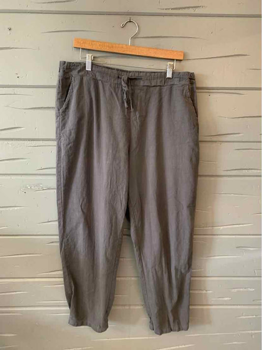 Gray casual pants in 2XL with elasticized waistband and tapered legs hanging on wooden hanger.