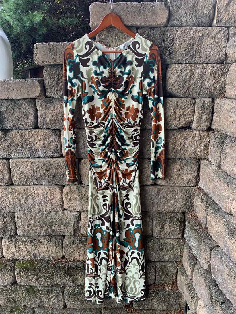 Long-sleeve fitted dress with multicolored floral and abstract patterns in teal, brown, and cream.