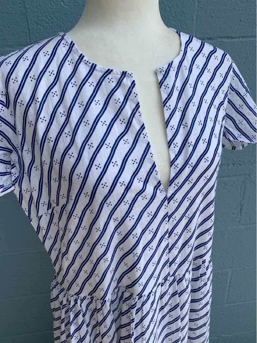 White dress with diagonal navy stripes and short sleeves, featuring a deep V-neck and gathered waist.