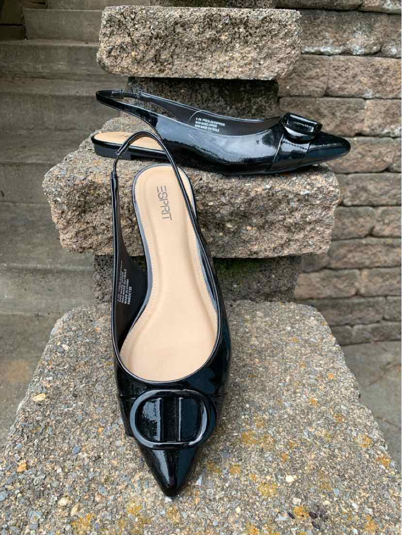 Black patent leather slingback shoe with pointed toe and decorative buckle, size 9.5.