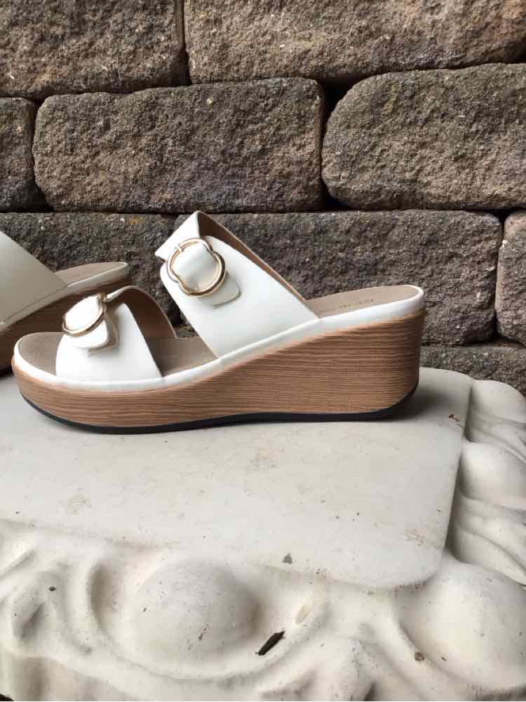 White leather wedge sandals with double straps and gold buckle detail, size 39.
