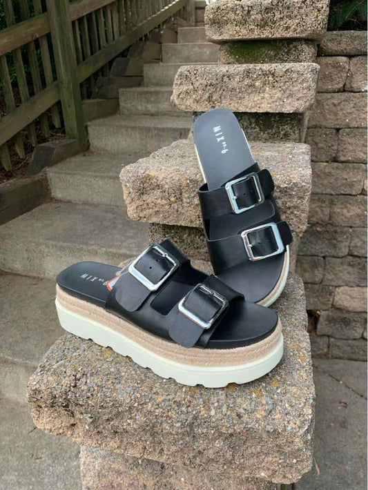 Black platform sandals with three adjustable buckle straps, white chunky sole, size 9.5.