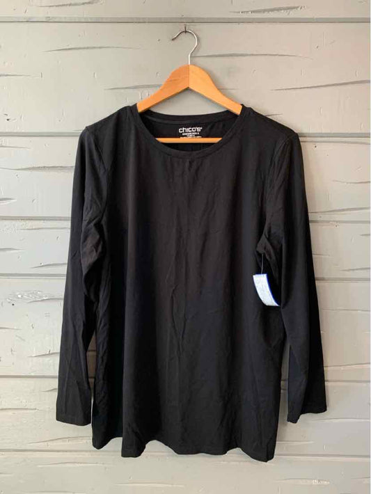Black Chico’s long-sleeve crewneck top with a relaxed fit and subtle orange neckline trim.