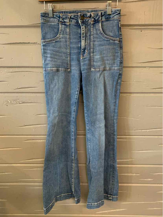 High-waisted light blue denim jeans with front patch pockets and flared legs.