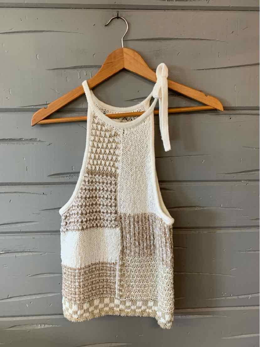 White and beige knit sleeveless top with mixed textured patterns and tie shoulder straps.