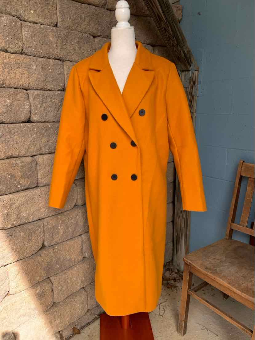 Bright orange double-breasted long coat with black buttons, notched lapels, and a belted waist.