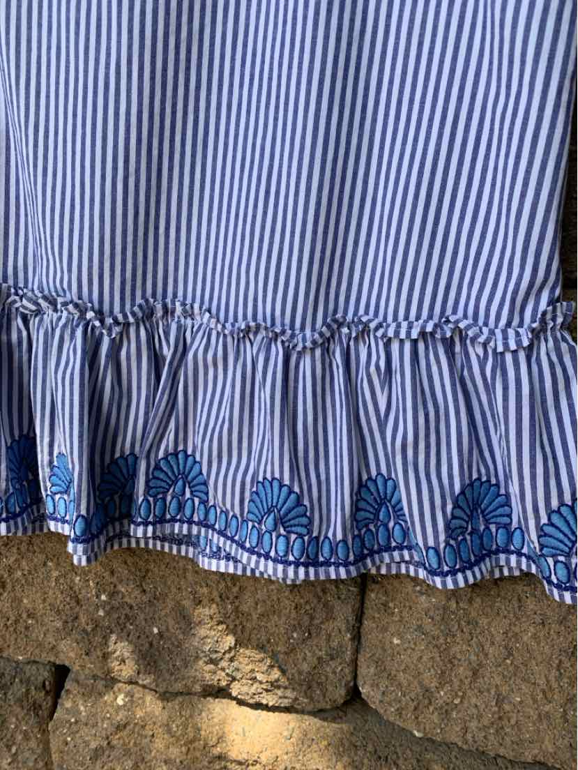 Blue and white vertical striped fabric with ruffled hem and embroidered blue floral trim.
