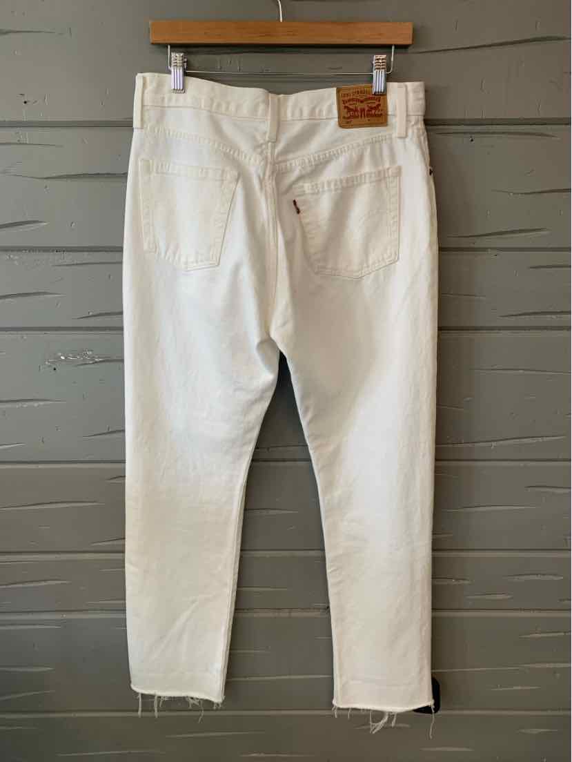 White Levi's jeans size 8 with leather patch on back waistband and raw hem cuffs.