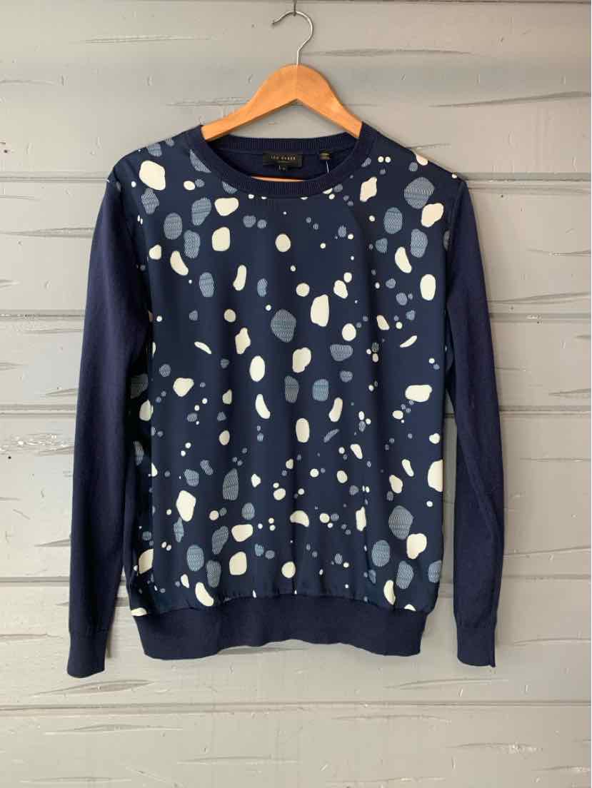 Navy blue sweatshirt with white and beige abstract spots, crew neck, long sleeves, relaxed fit.