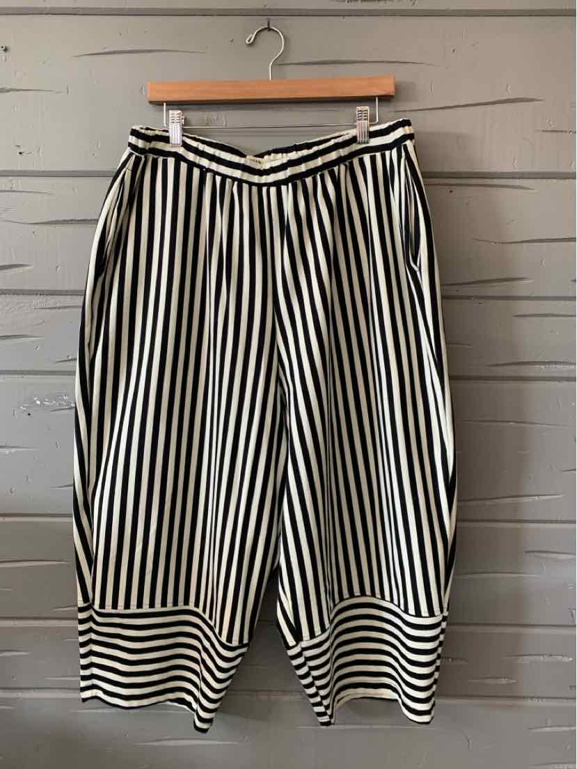 Black, white, and beige vertically striped Alembika wide-leg pants with elastic waist and striped cuffs.