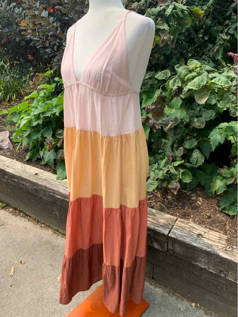 Sleeveless tiered maxi dress with V-neck in pink, yellow, orange, and brown color blocks.