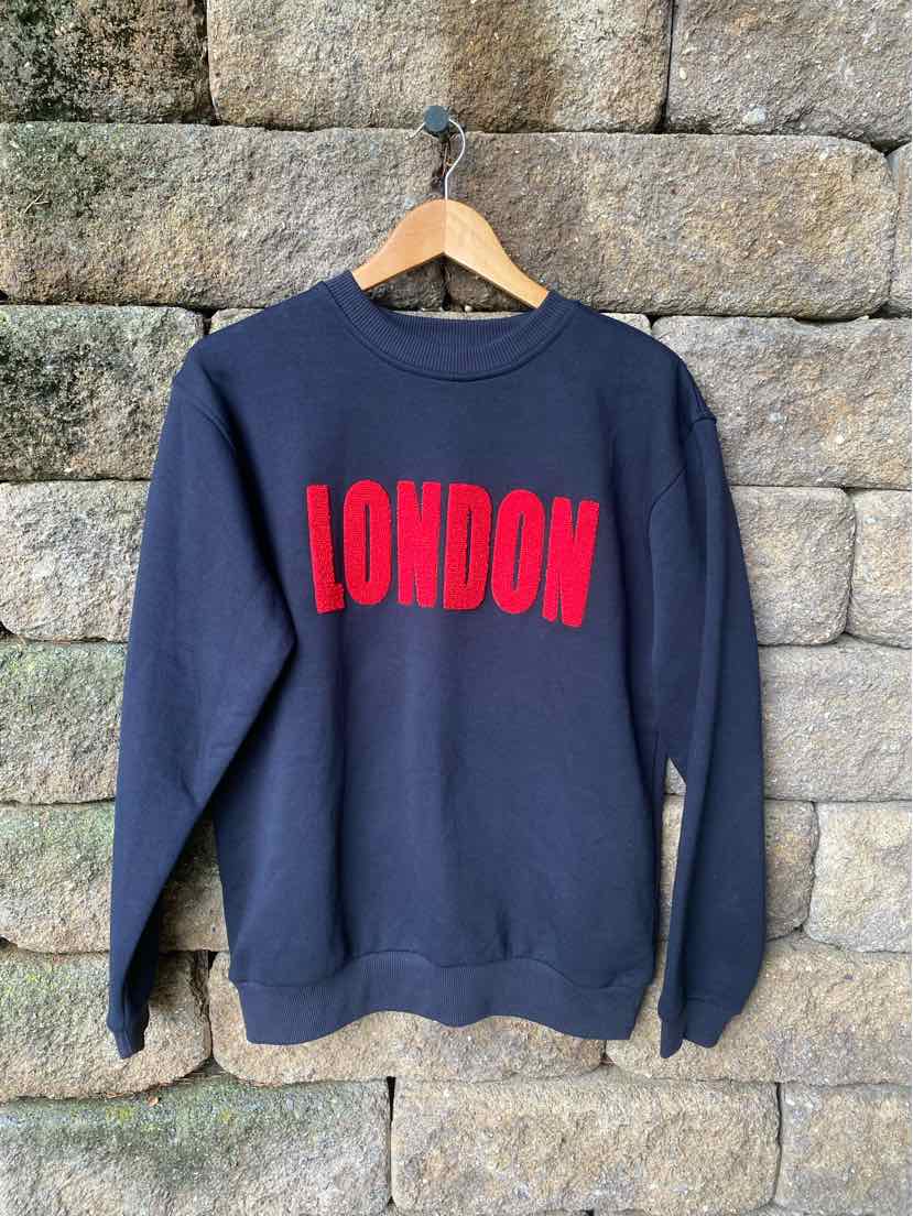 Navy blue crewneck sweatshirt with bold red "LONDON" text across the chest.
