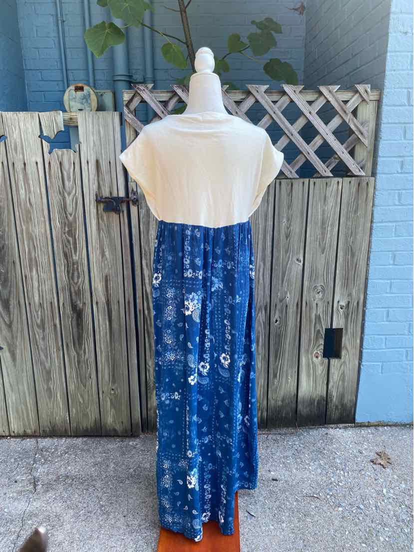 Blue paisley print maxi dress with white short sleeves and high neckline on mannequin.
