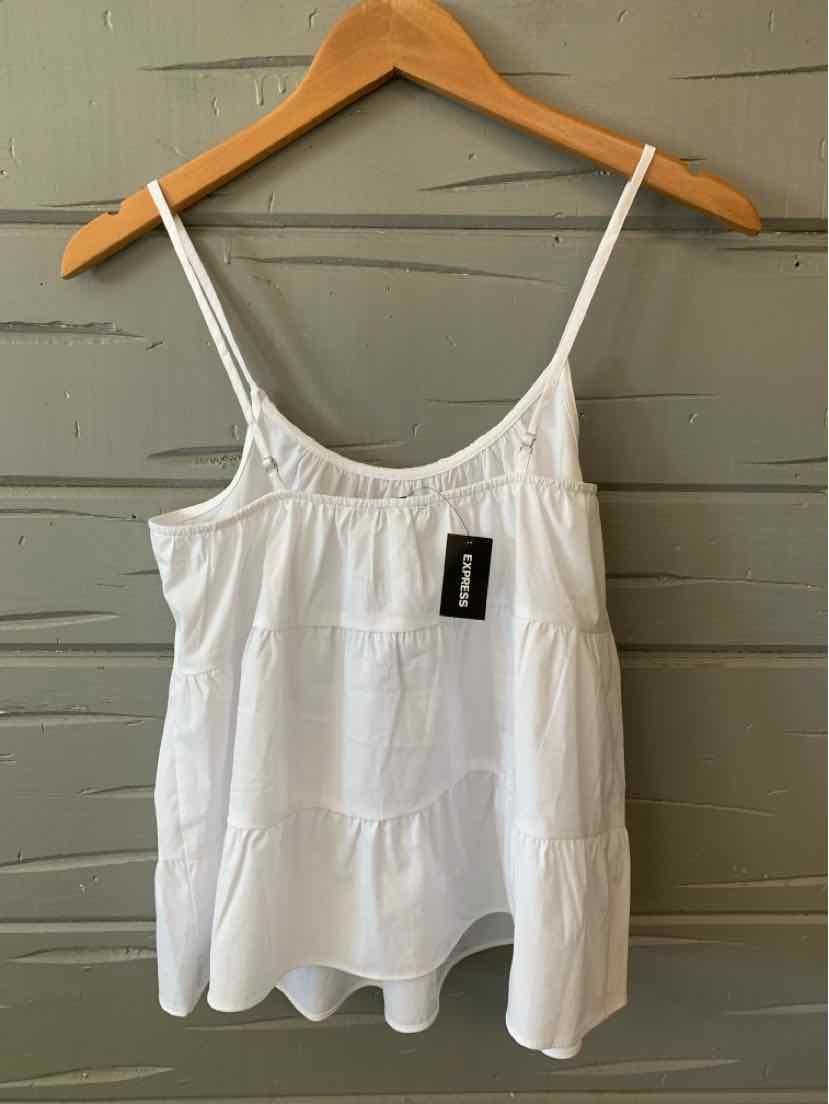 White sleeveless flowy tank top with thin adjustable straps and subtle tiered design.