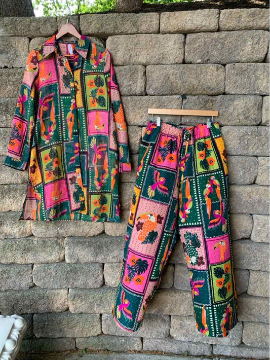 Colorful two-piece outfit with long-sleeve button-up shirt and matching pants featuring green, pink, and orange parrot.